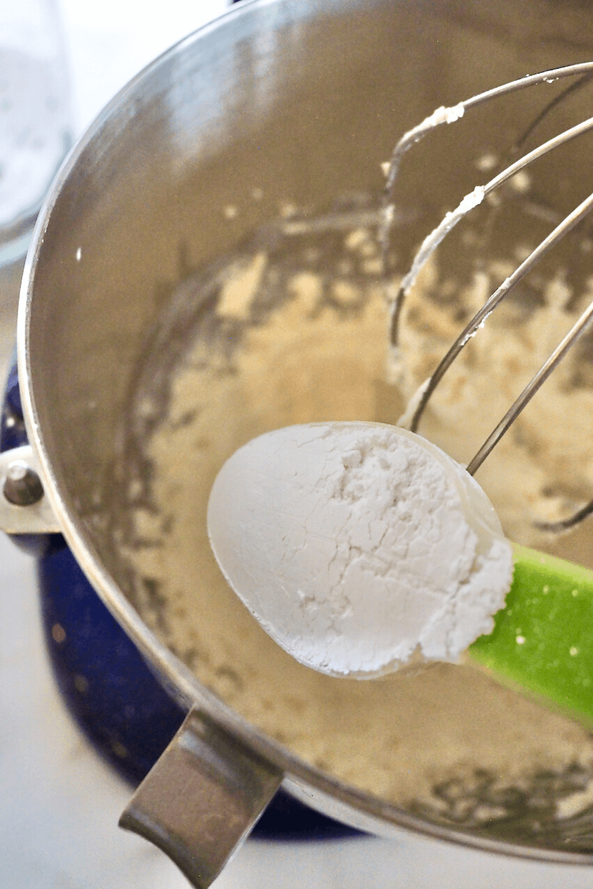 Adding powdered sugar to cream cheese mixture. 