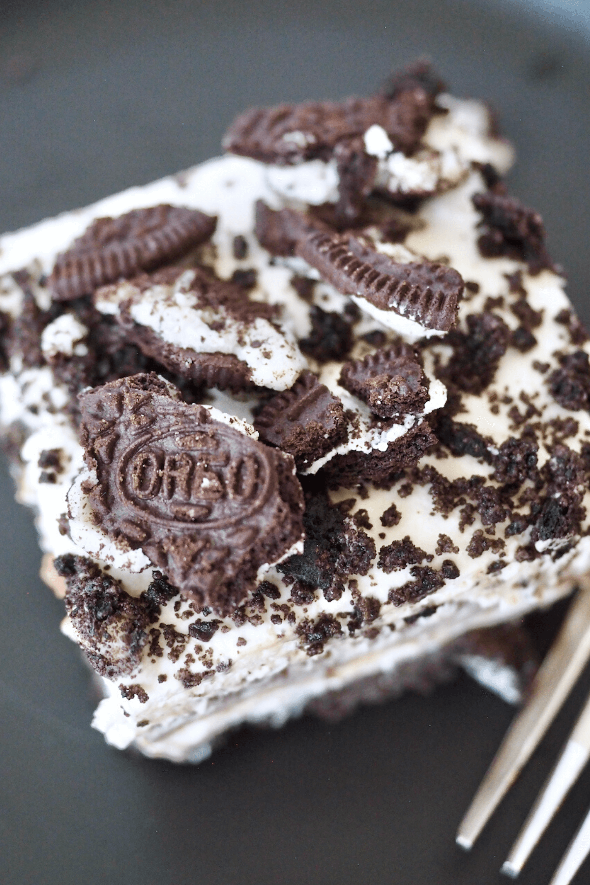 Oreo dessert without Cool Whip square slice on a plate with a fork.