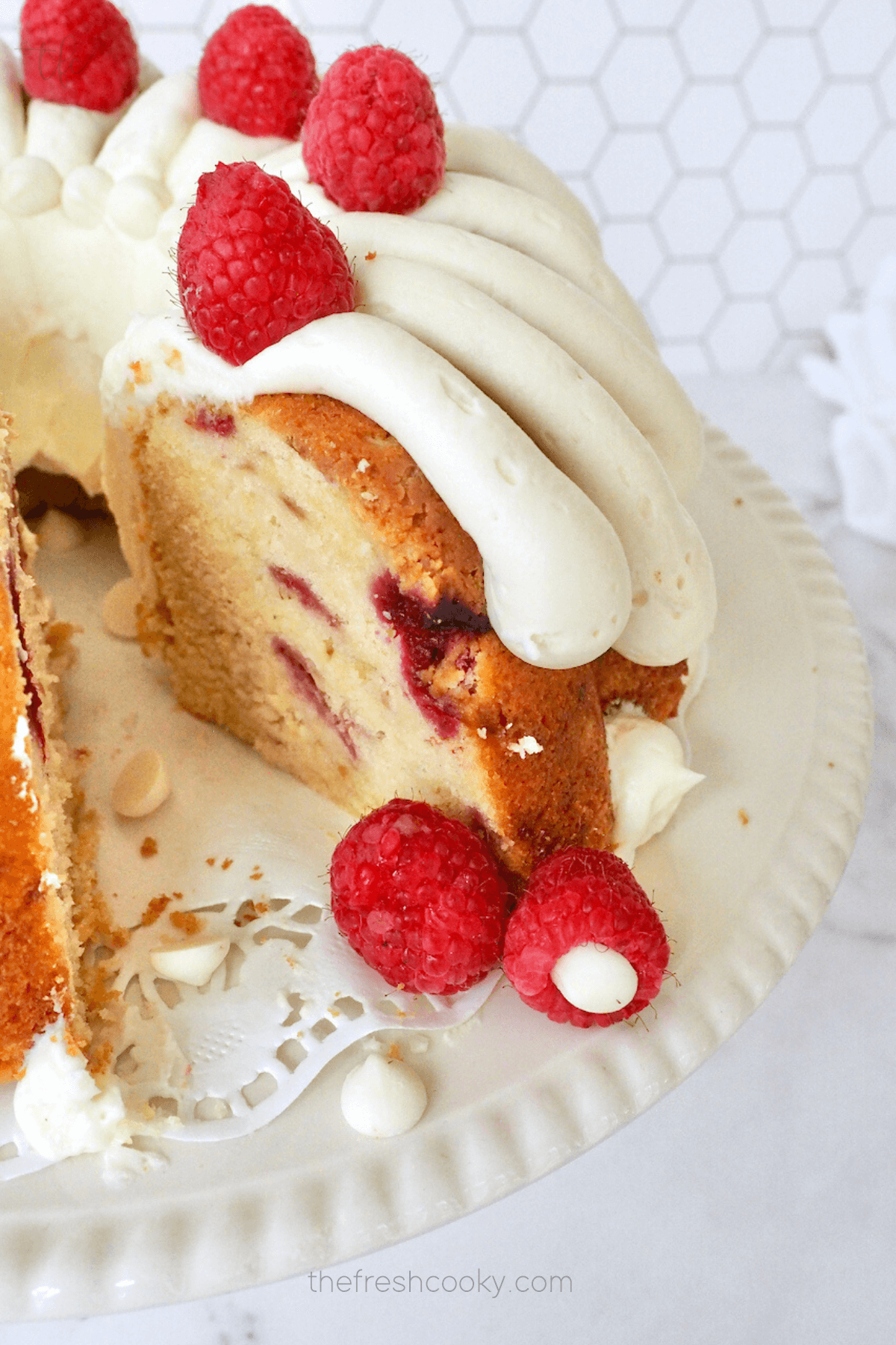 Slice removed from white chocolate raspberry bundt cake.