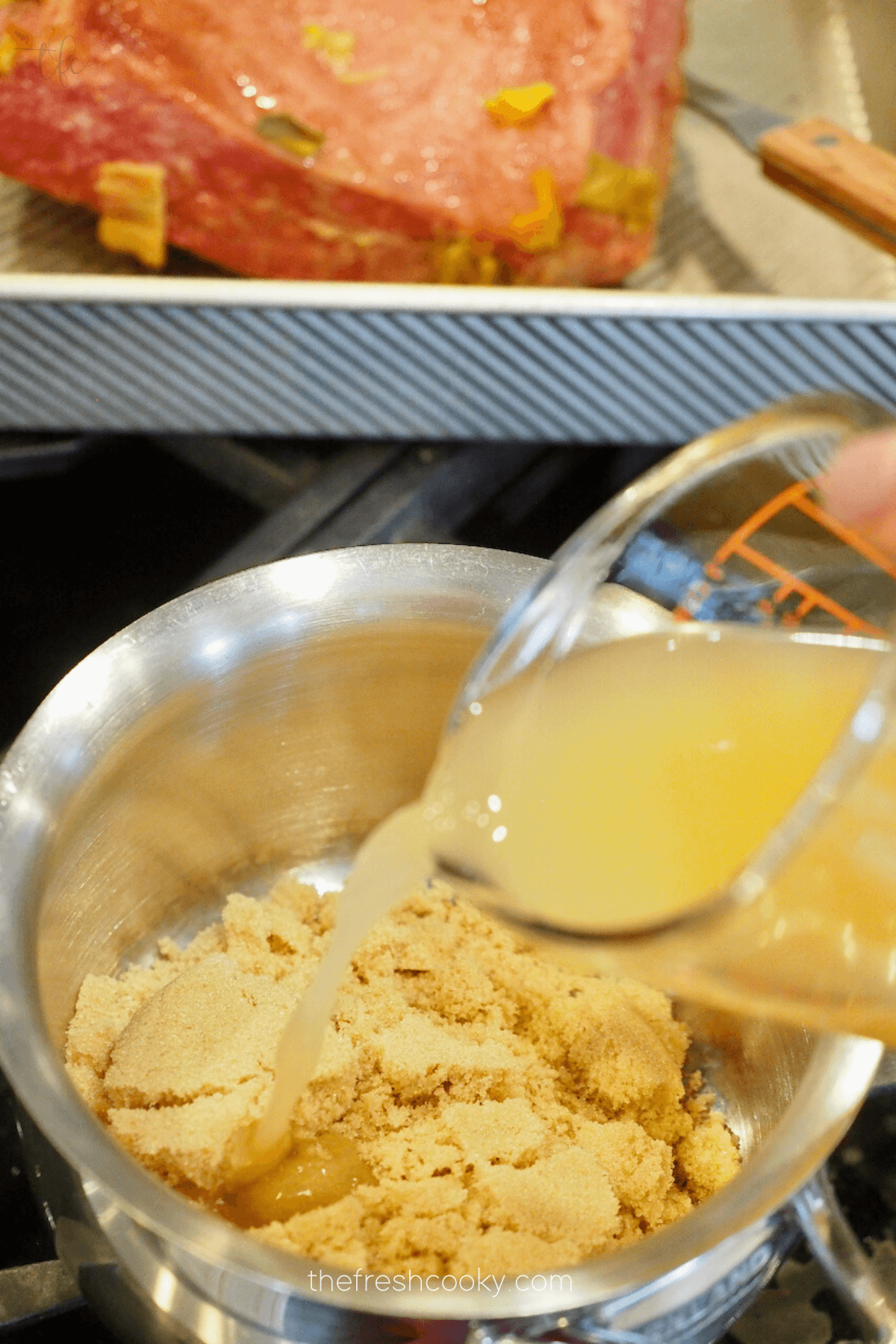 Pouring apple juice on top of brown sugar for baked corned beef recipe.