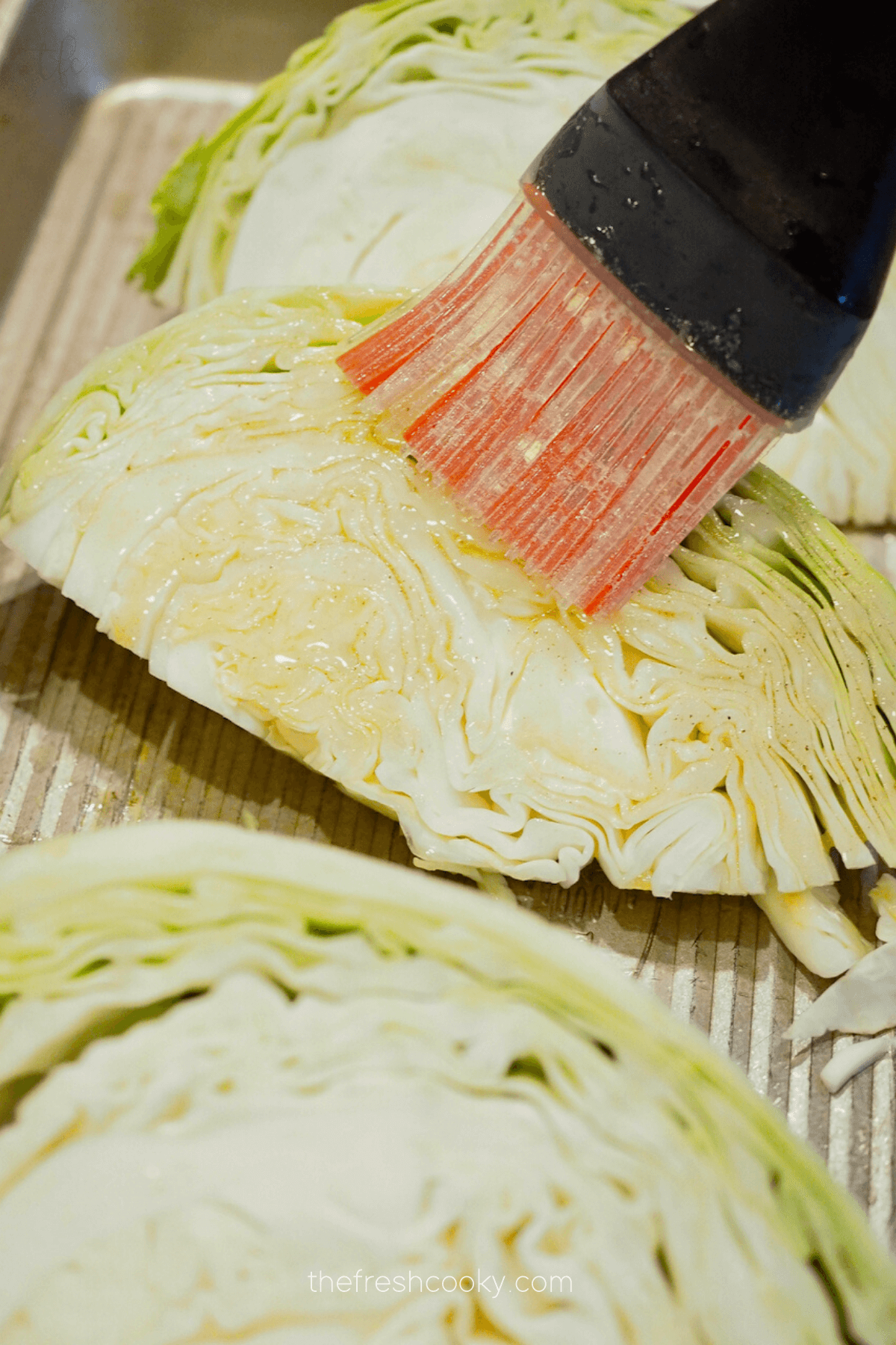 Brushing cabbage wedges with browned butter for baked corned beef recipe. 