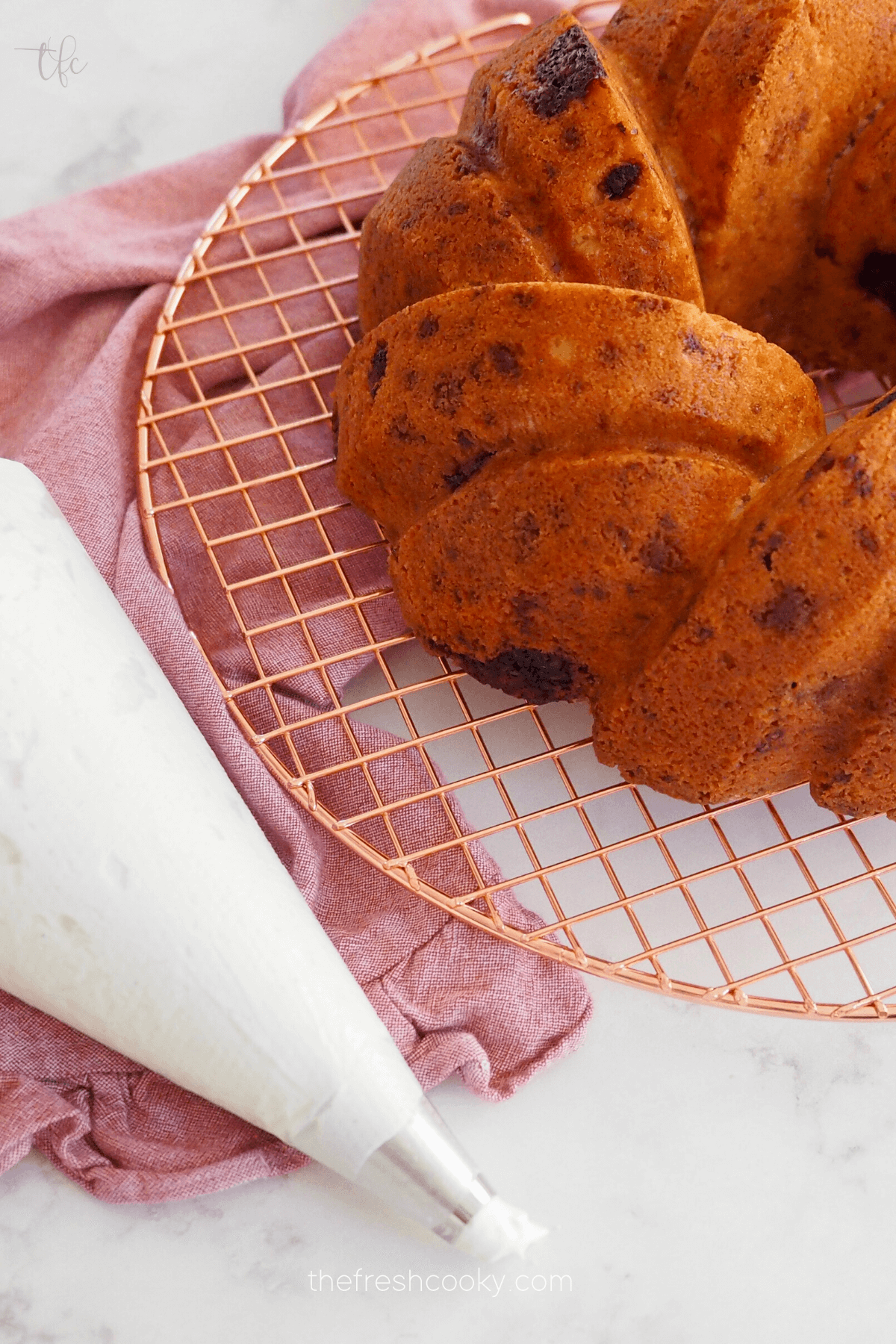 Baked cake with frosting in piping bag. 