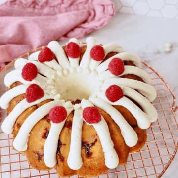 cropped-Frosted-and-decorated-White-Chocolate-Raspberry-Bundt-Cake.png