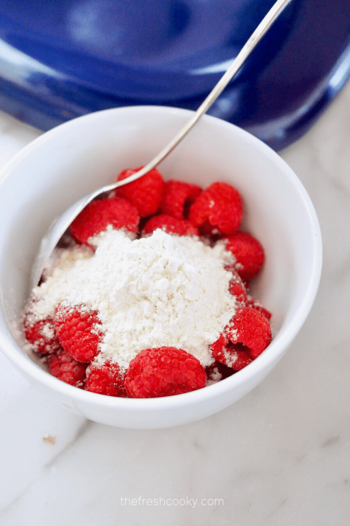 Gently fold 1-2 tablespoons flour to raspberries.