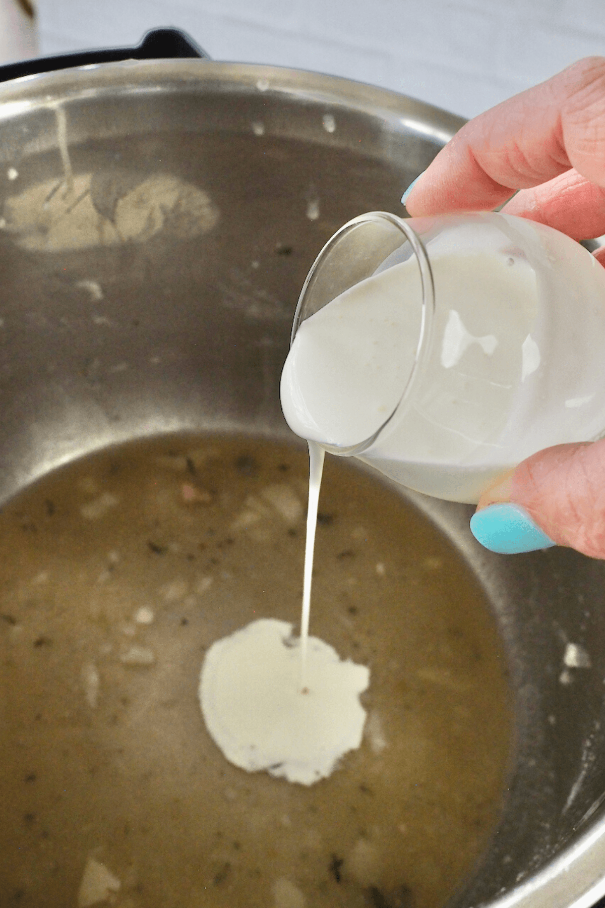 Pour cream into instant pot and mix with broth. 