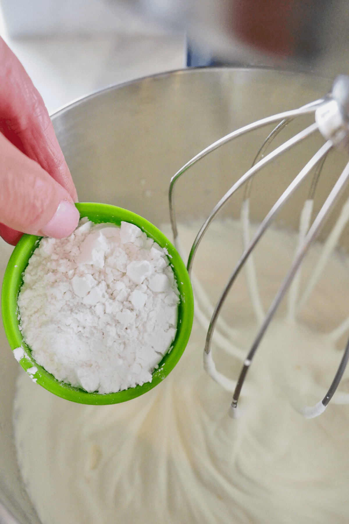 Adding powdered sugar to soft whipped cream for stabilized whipped cream. 