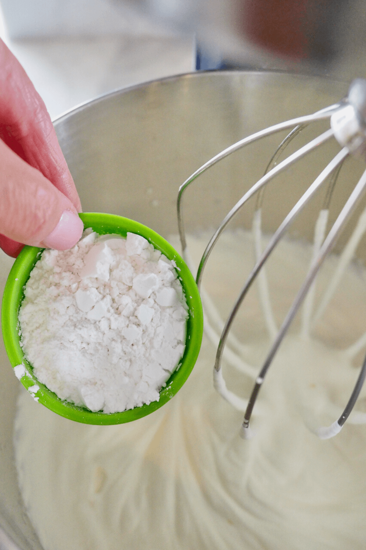 Adding powdered sugar to soft whipped cream for stabilized whipped cream.