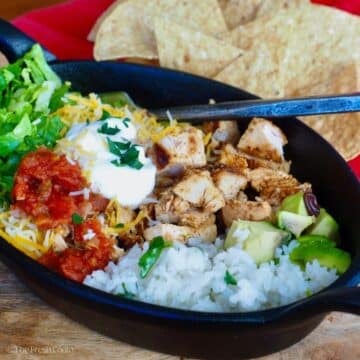 A copycat bowl full of Chipotle chicken, cilantro lime rice and toppings.