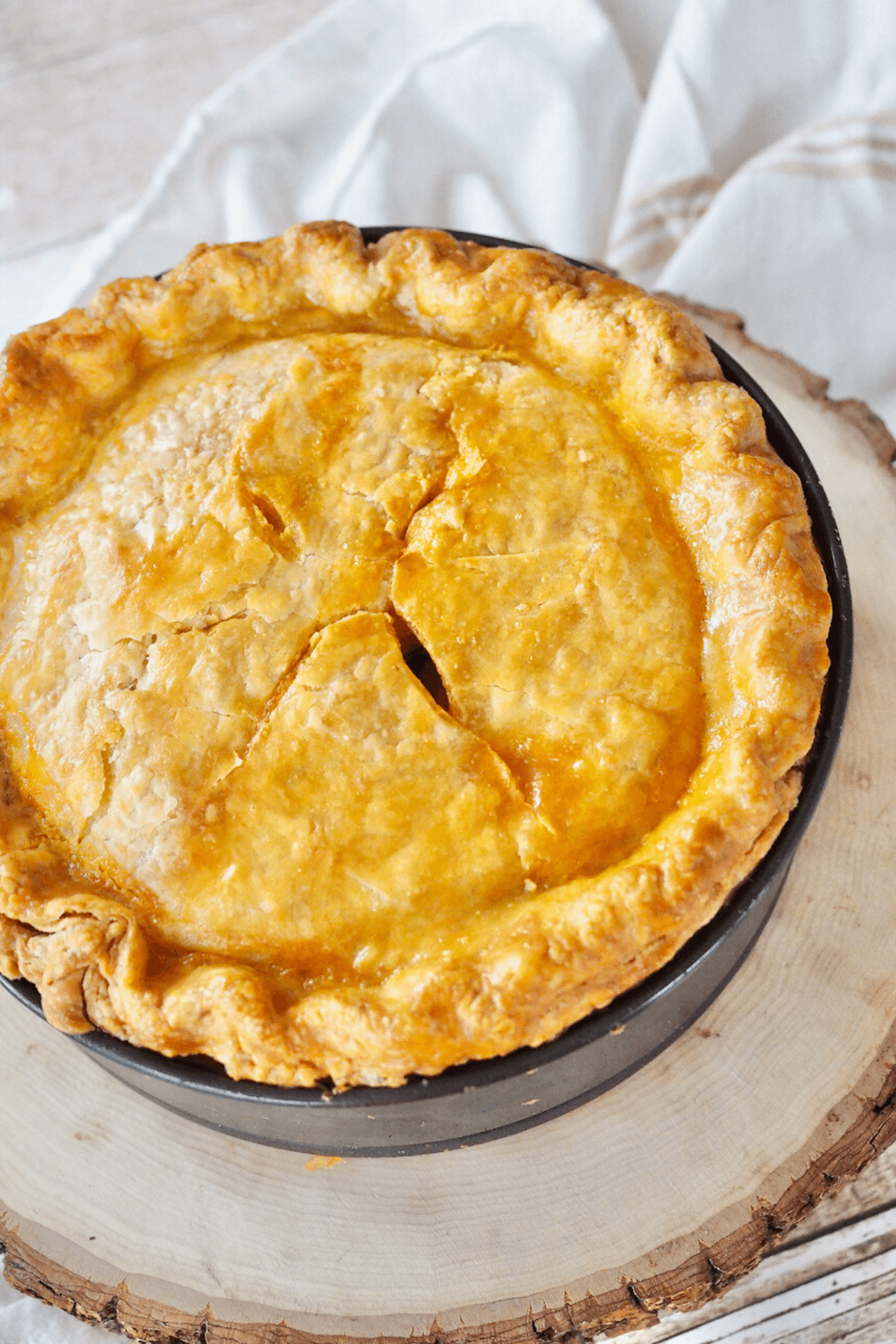 Baked Pizza Rustica on wooden tray.