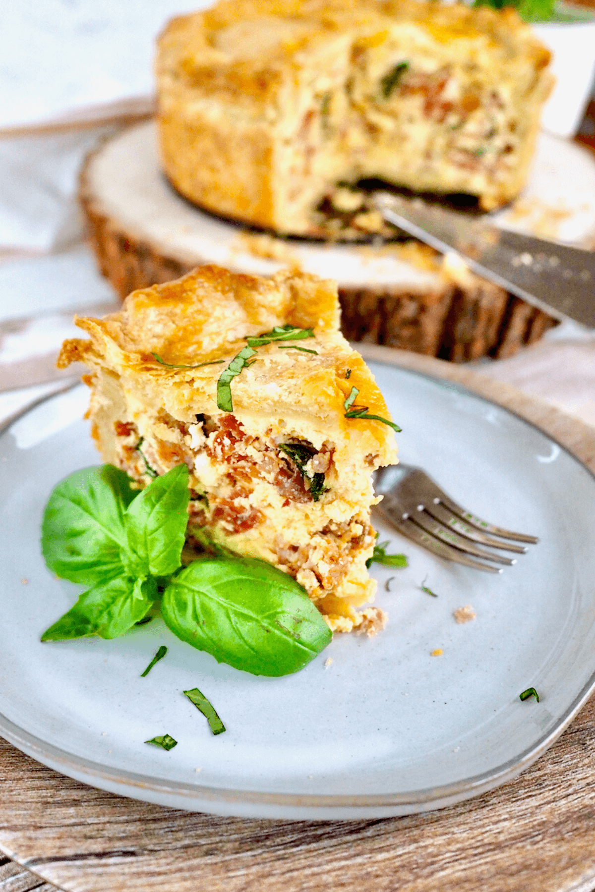 Italian Pizza Rustica Easter Pie slice on plate with basil.