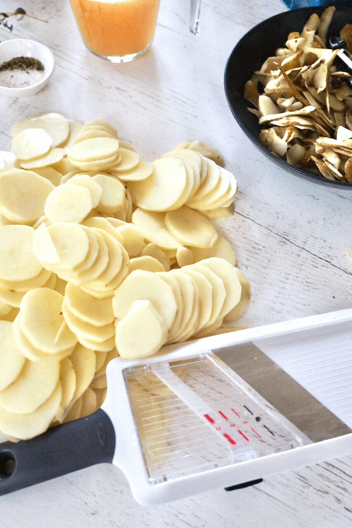 Mandoline slicer with sliced potatoes ready for Instant Pot. 