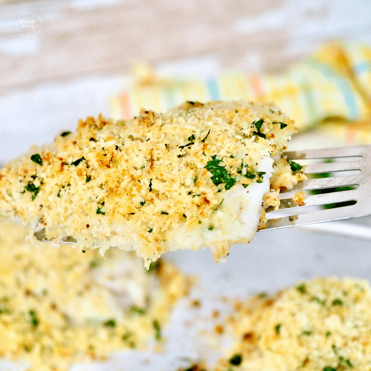 Panko parmesan baked cod recipe with spatula lifting piece.