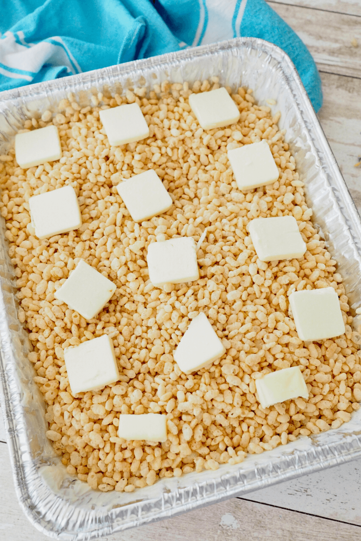 Pats of butter on top of rice krispies.