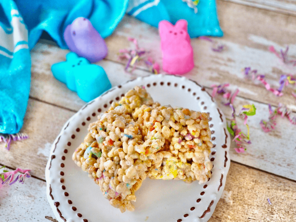 Easy Peeps Rice Krispie Treats in oven, on plate with colorful Peeps surrounding.