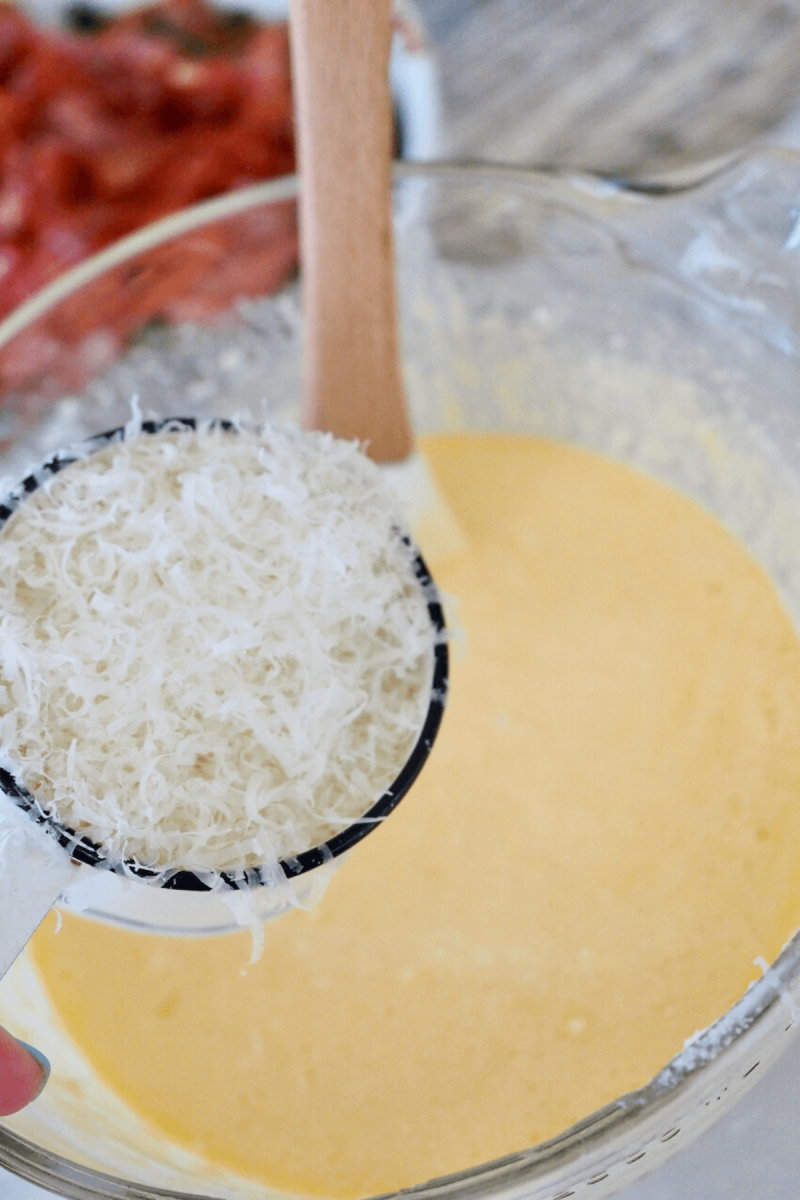 Adding cheeses to egg mixture.