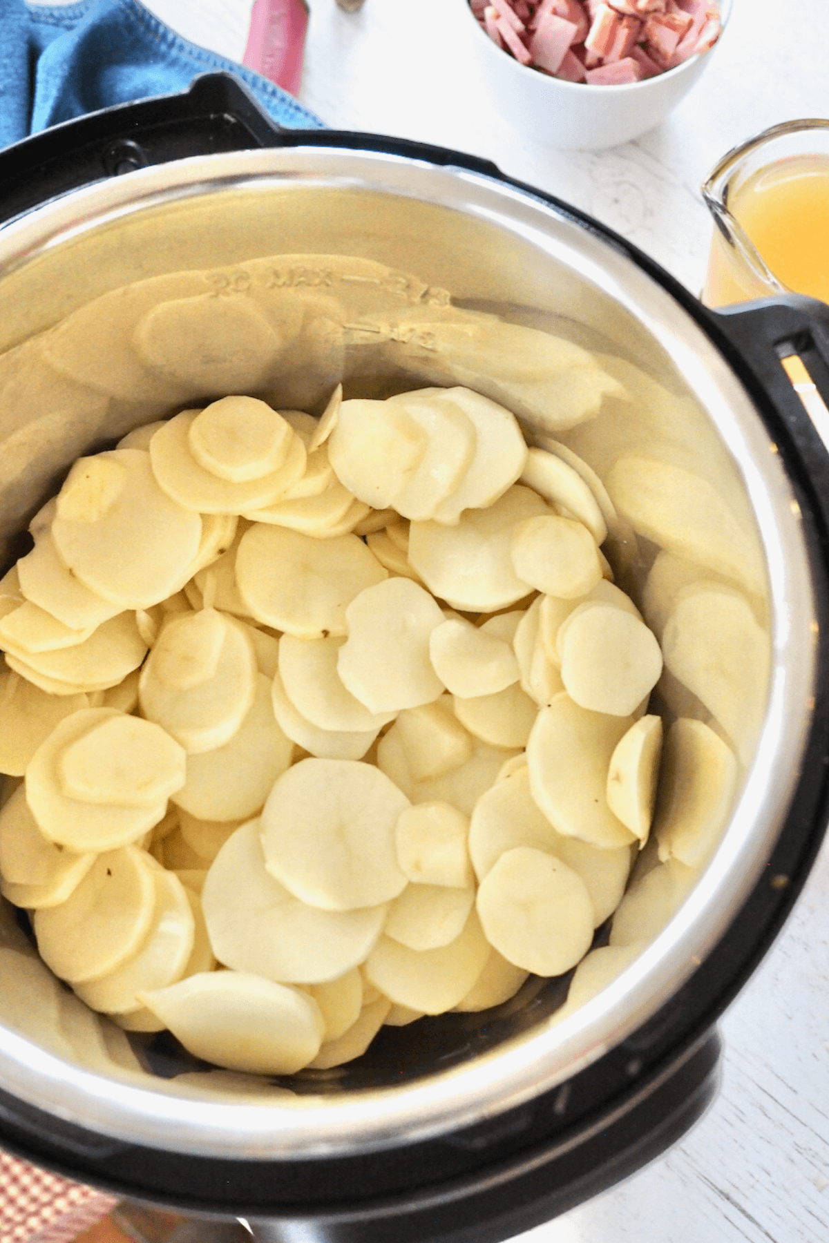 Layered potatoes inside instant pot. 
