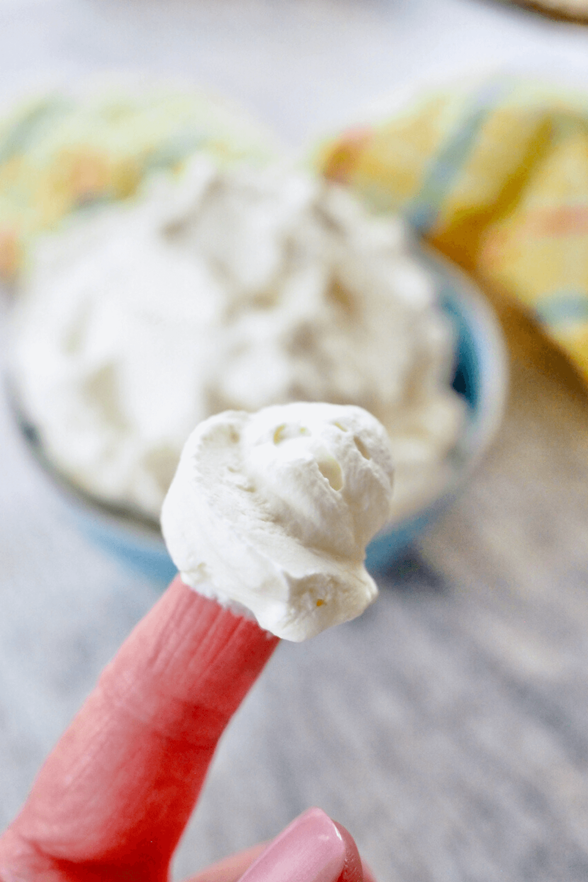 Stabilized whipped cream with bit on the finger.