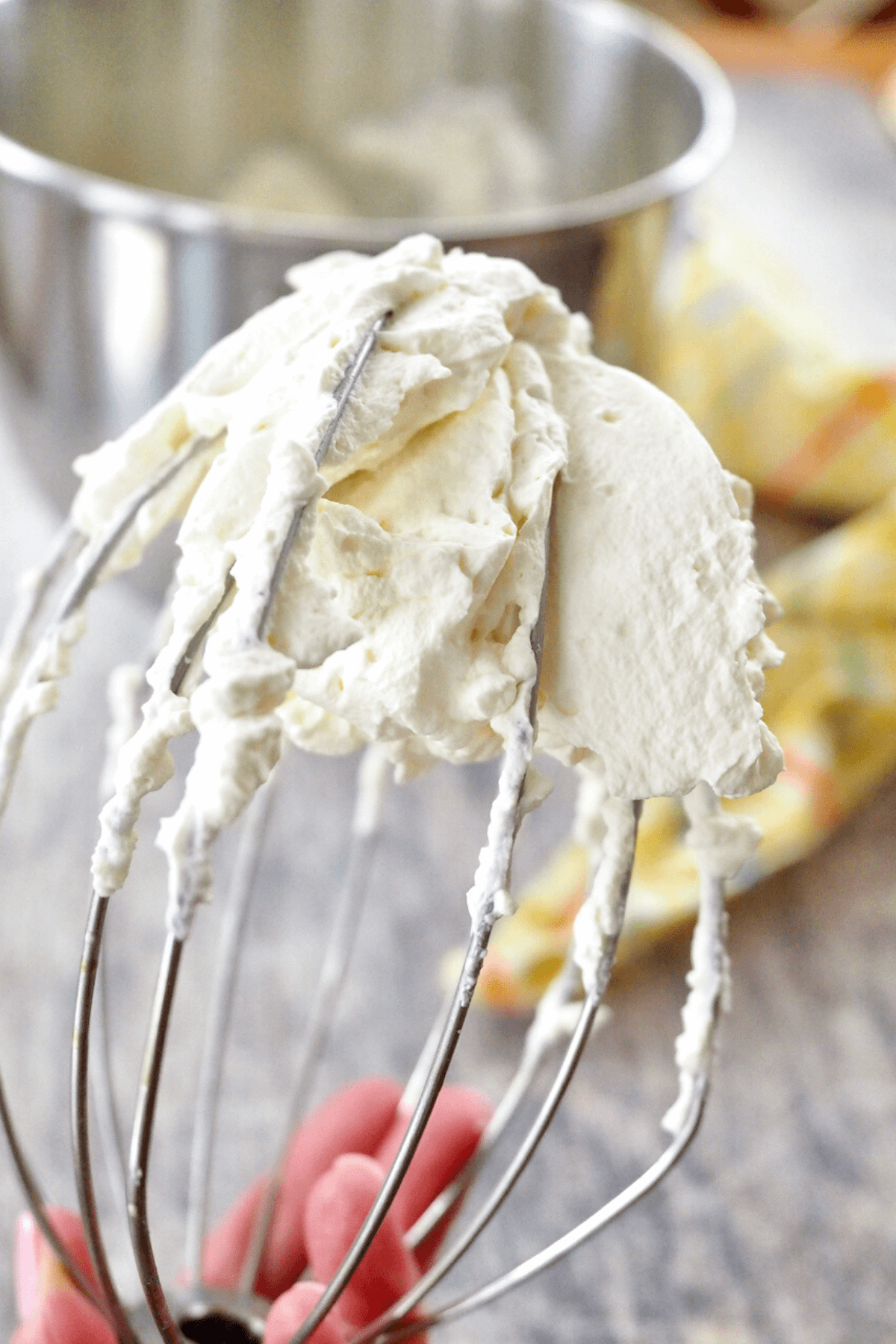 Stabilized whipped cream on wire whisk.