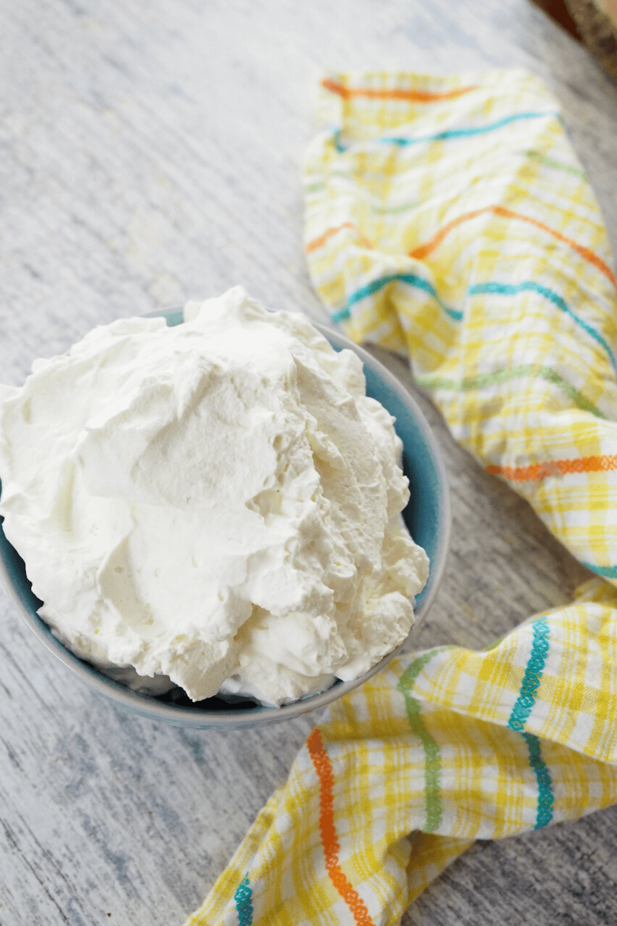 Stabilized whipped cream in blue bowl.