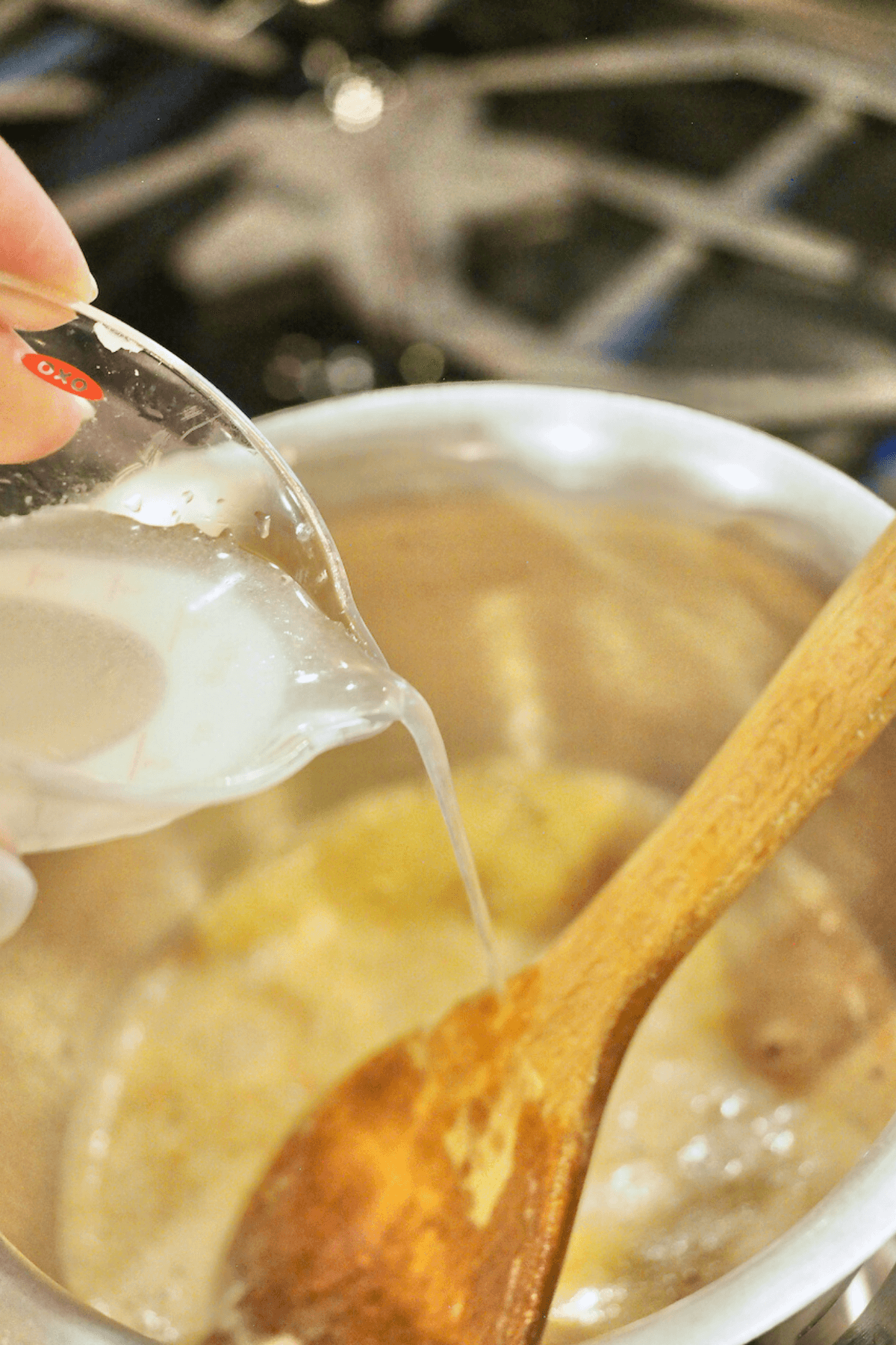 Pouring lemon juice into butter sauce. 
