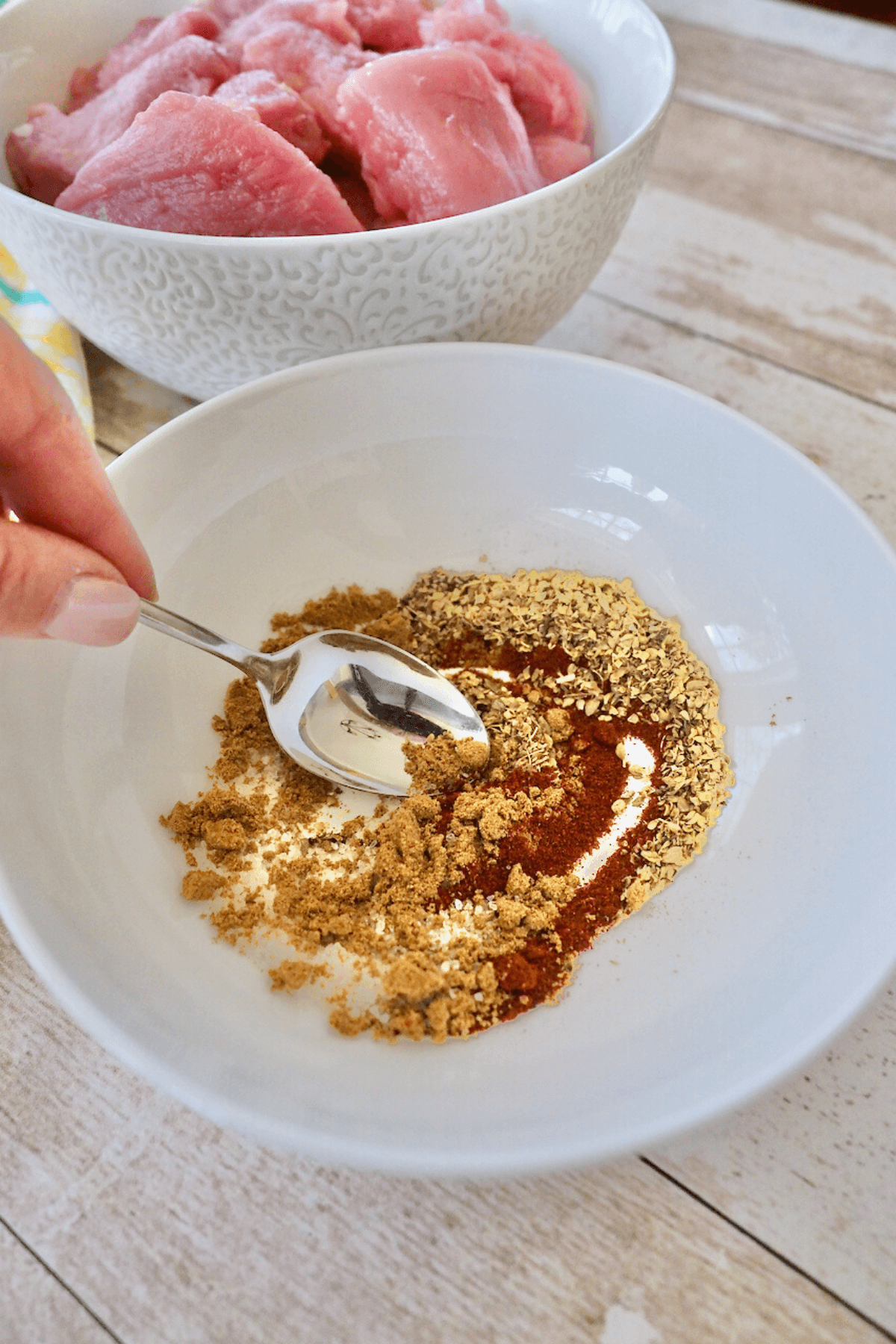 Stirring spices together to make pork spice rub for carnitas. 