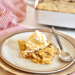 Caramel Apple Dump Cake Recipe slice on a plate topped with ice cream and a spoon on the side.