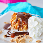 Air Fryer Fried Ice Cream on plate with swirl of whipped cream.