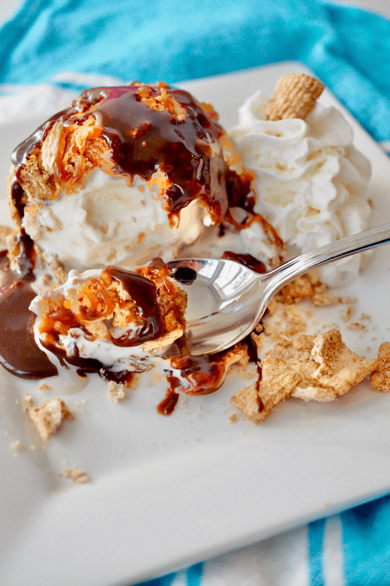 Air fryer fried ice cream on plate with spoon on a plate with crispy coating.