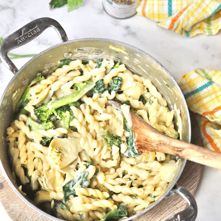 One pot lemon garlic pasta recipe in pot with wooden spoon.