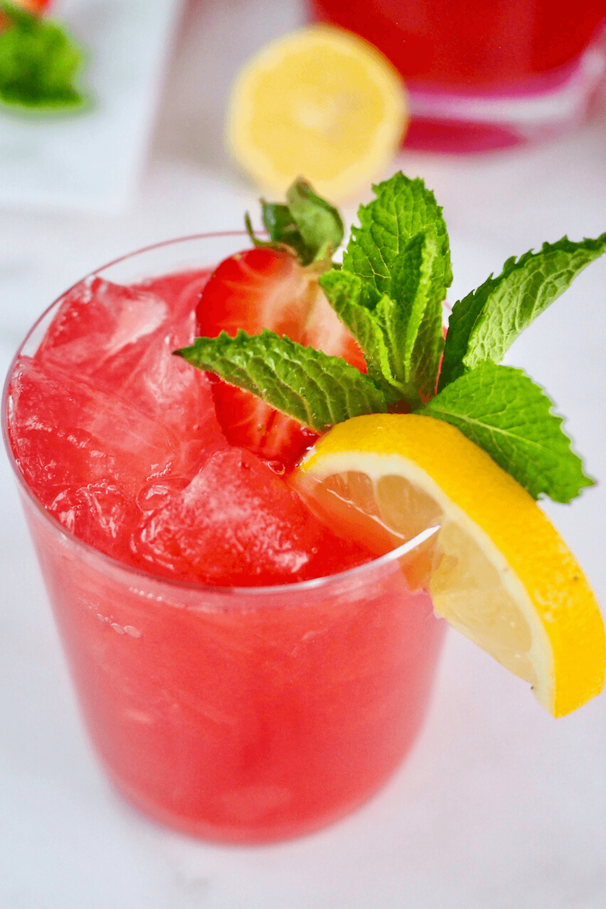 Gorgeous glass filled with bright pink vodka lemonade. 