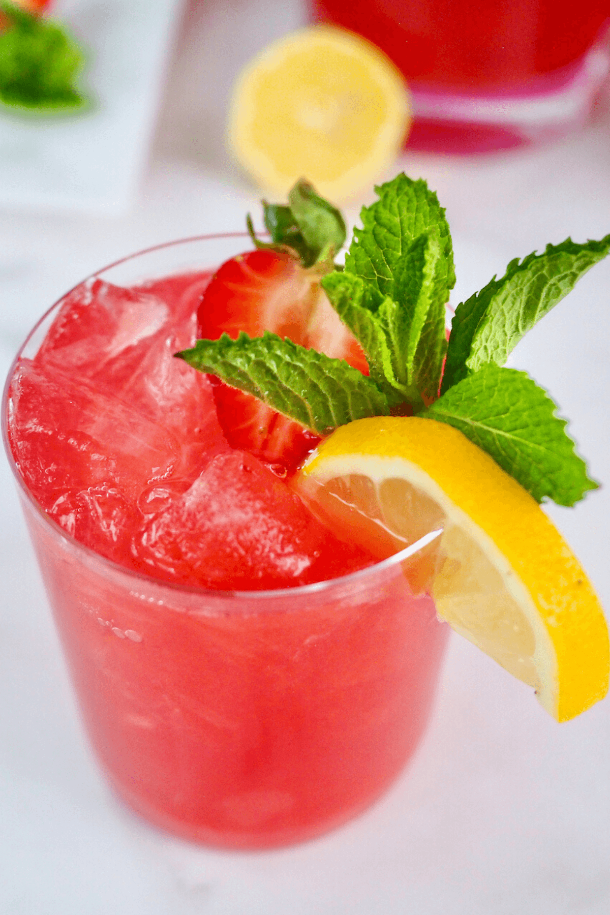 Gorgeous glass filled with bright pink vodka lemonade.