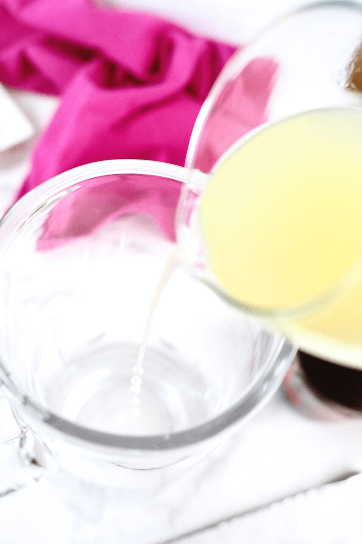 Pouring lime and lemon juice into the pitcher.