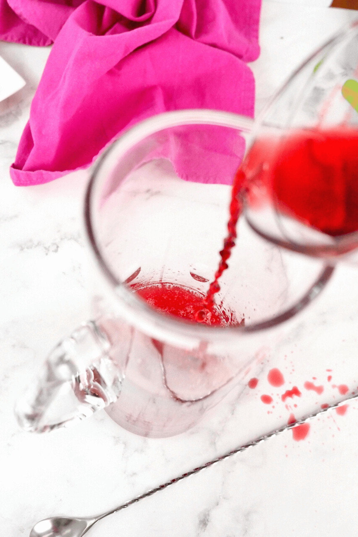 Pouring the pomegranate juice into the pitcher for vodka lemonade.