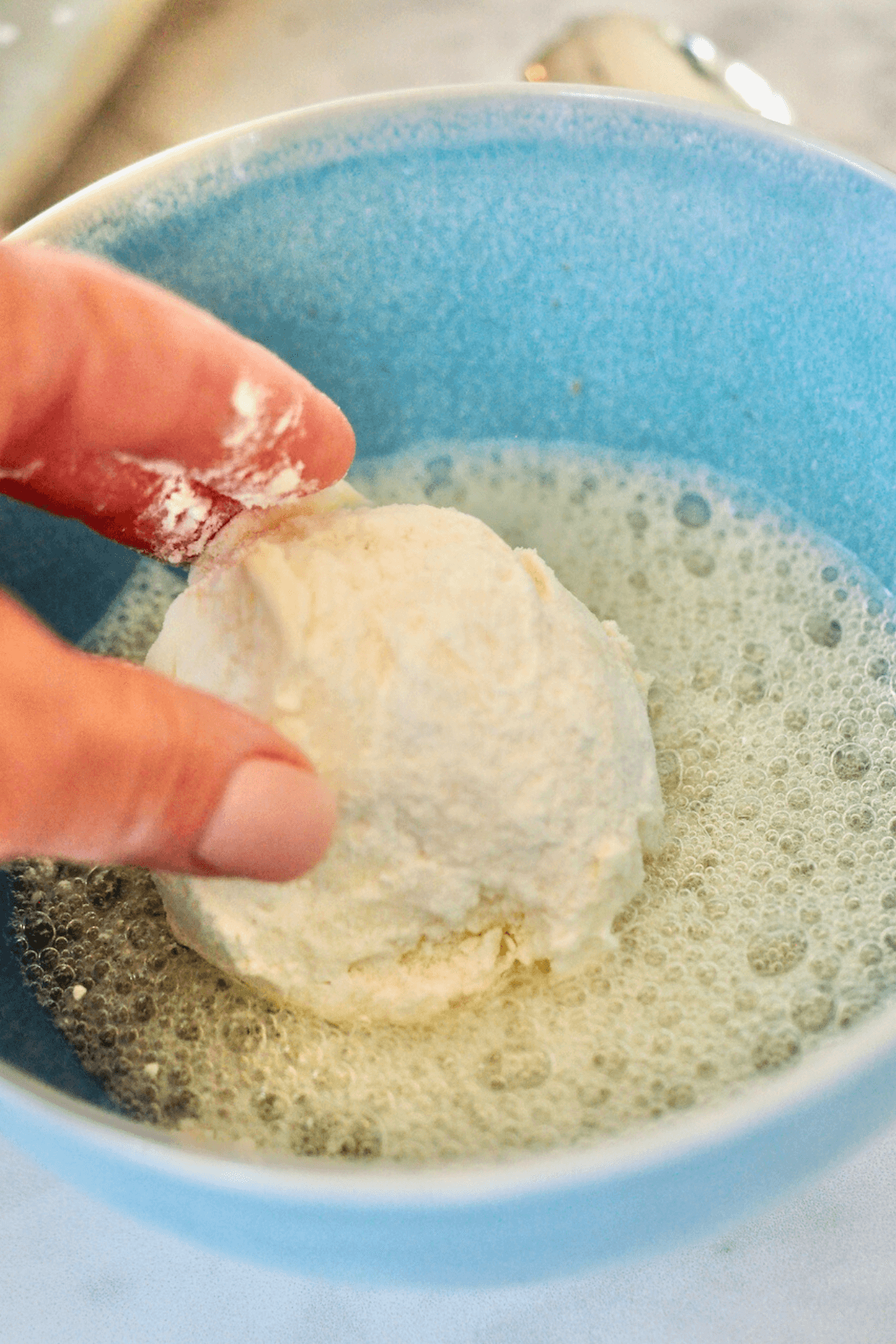 Rolling frozen ice cream balls in egg whites. 