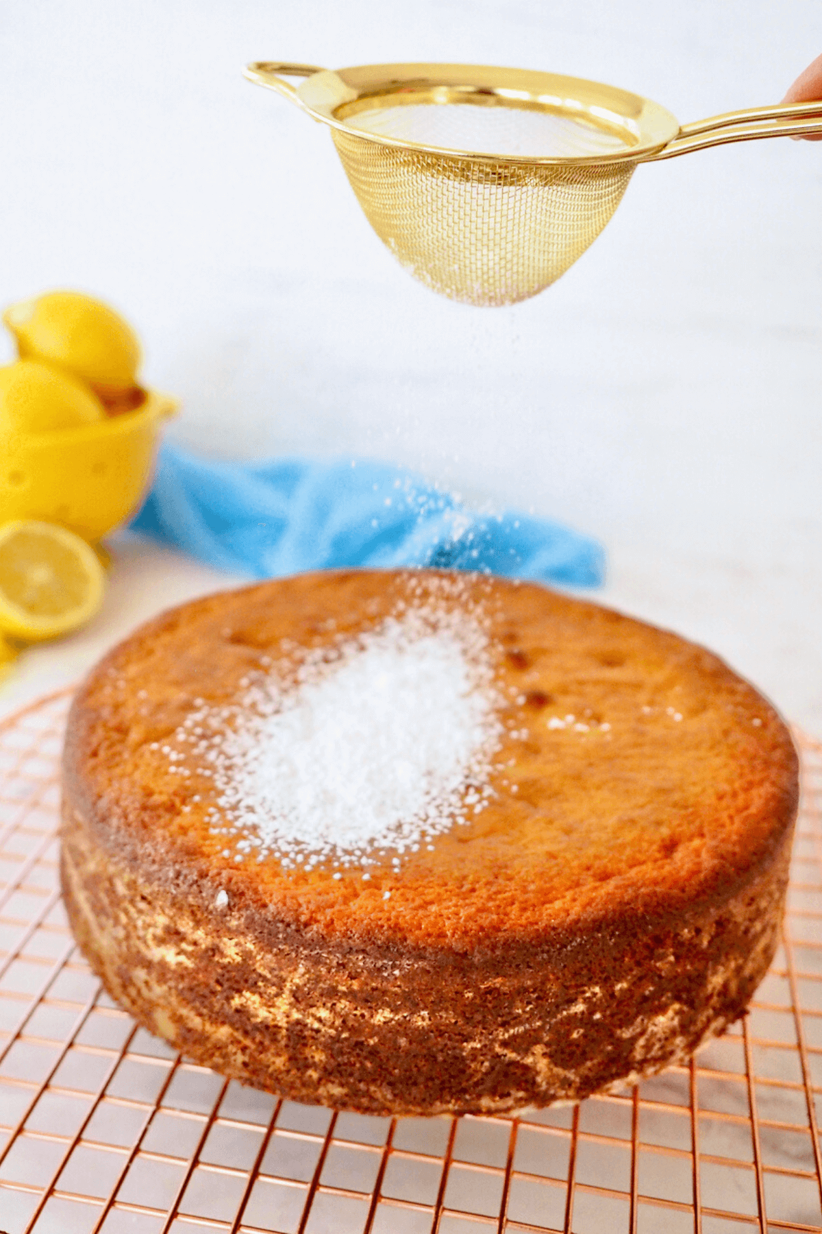 Dusting the cake with powdered sugar before serving.