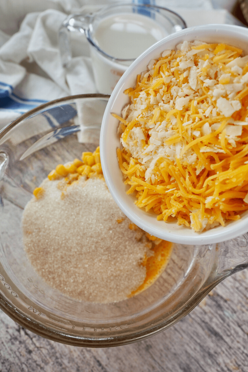 Add shredded cheese to cornbread mixture.