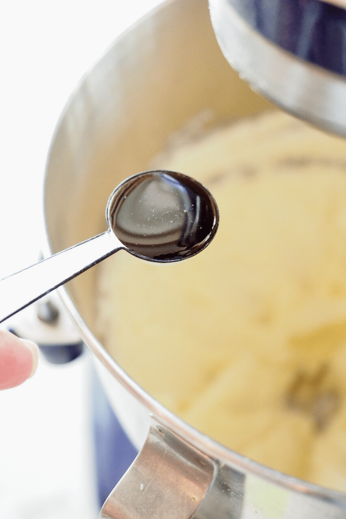 Adding vanilla bean paste into cream cheese frosting.