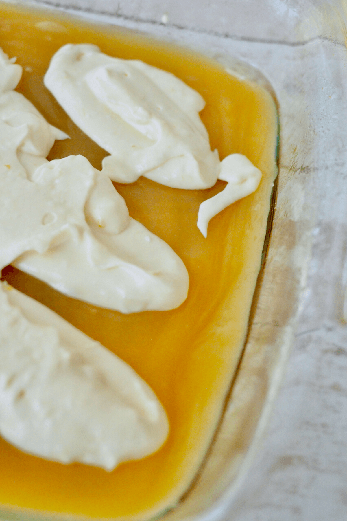 Place dollops of cream cheese mixture on top of lemon curd. 