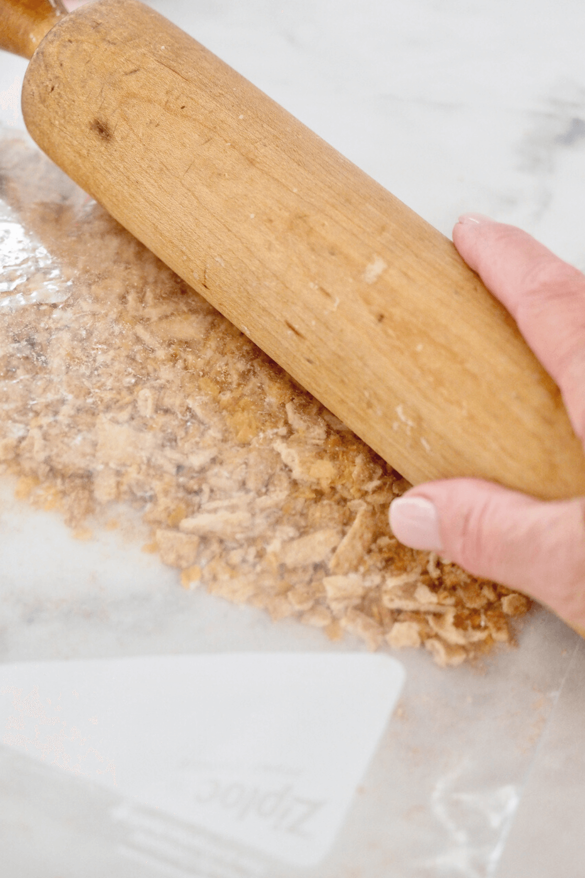 Crushing cereal with rolling pin. 