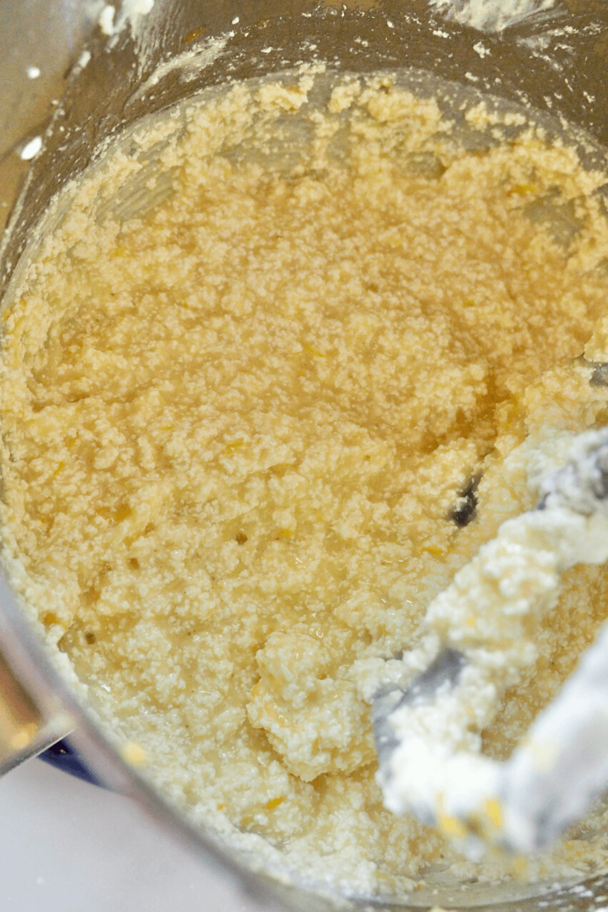 Ricotta cake batter looking curdled before adding flour mixture. 