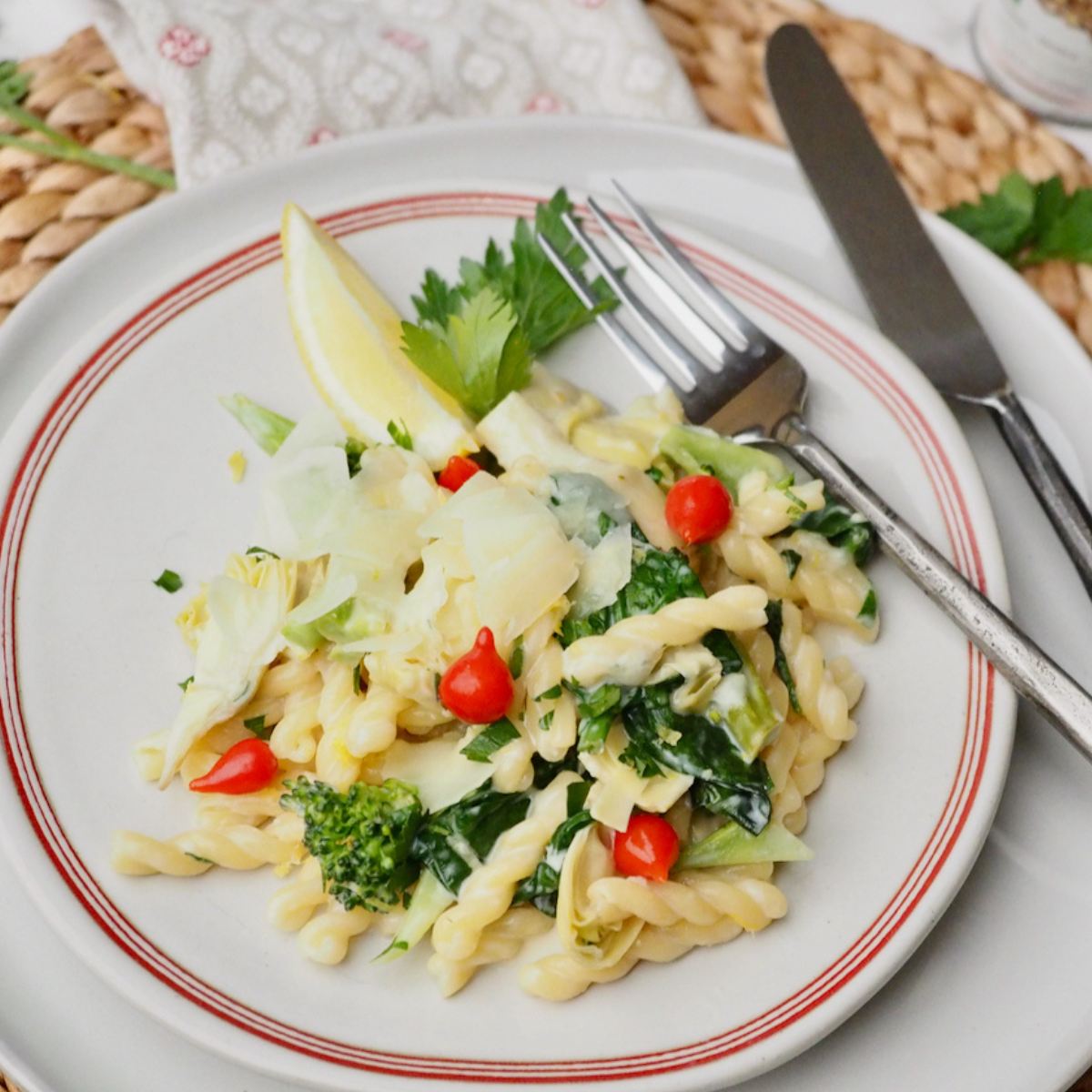 Plate and fork with serving of garlic lemon pasta with veggies.