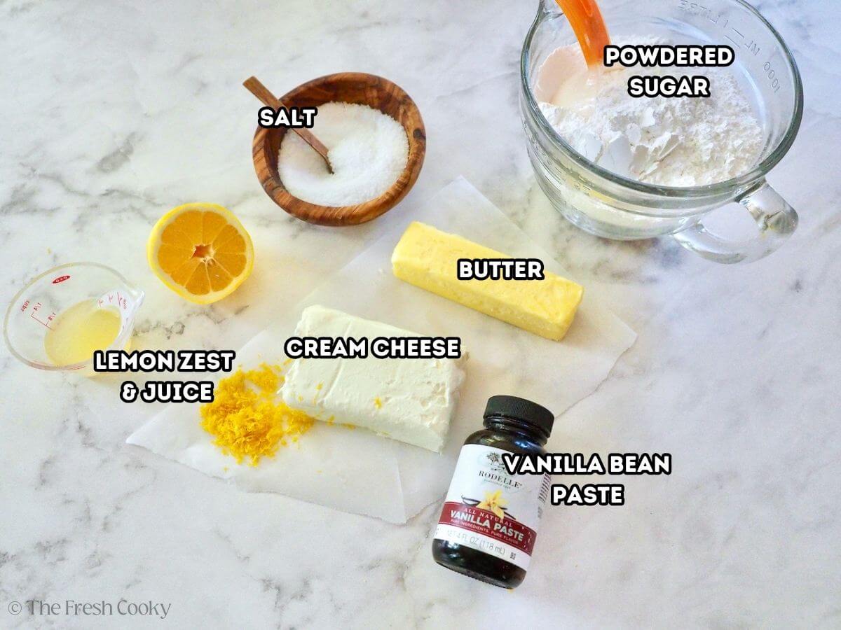 Lemon cream cheese frosting ingredients. L-R: lemon juice, lemon zest, salt, cream cheese, butter, vanilla extract, and powdered sugar.
