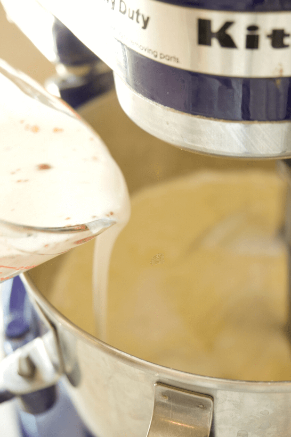 Pouring buttermilk into rhubarb cake batter. 