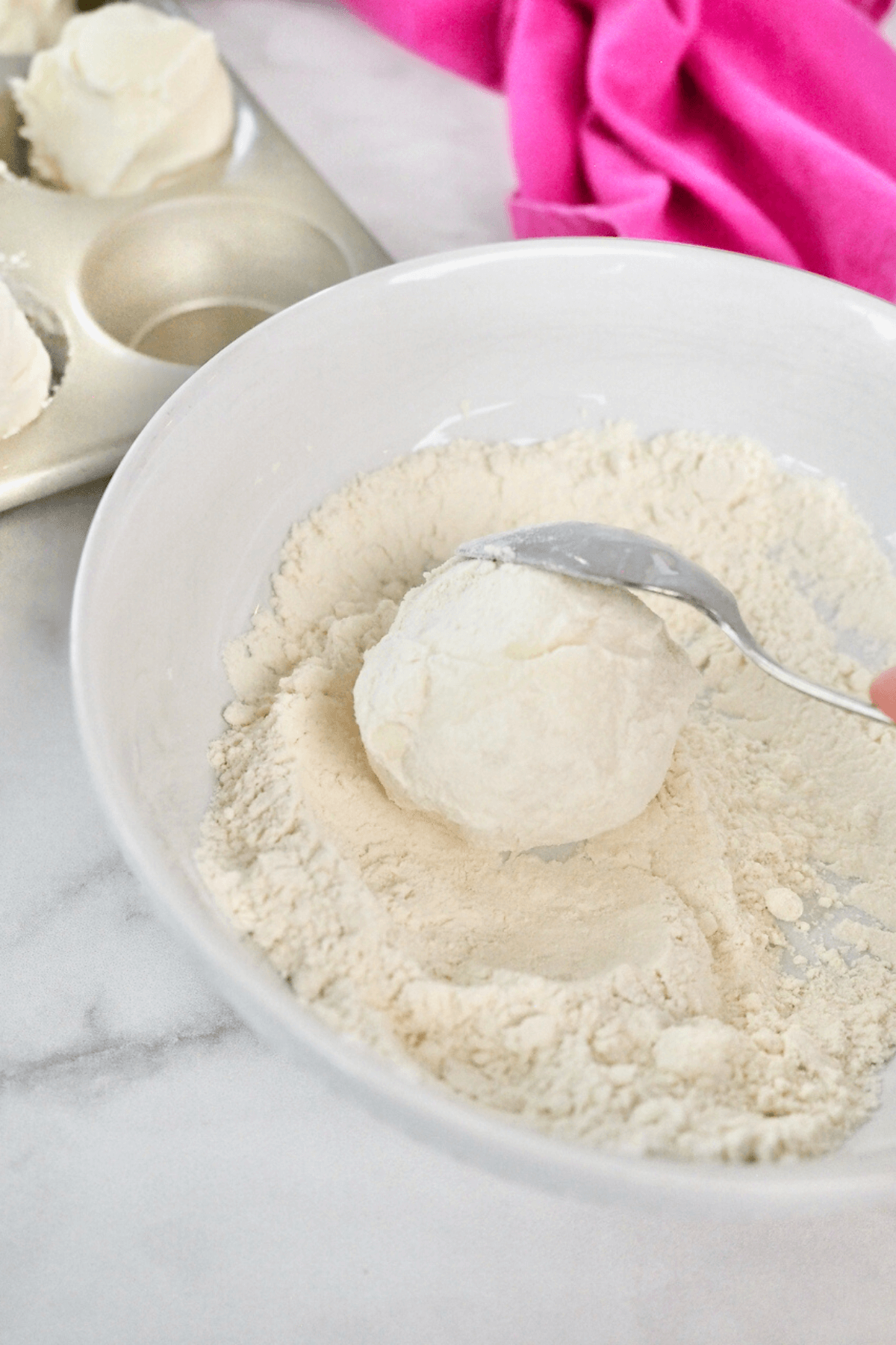 Rolling ice cream balls in flour. 