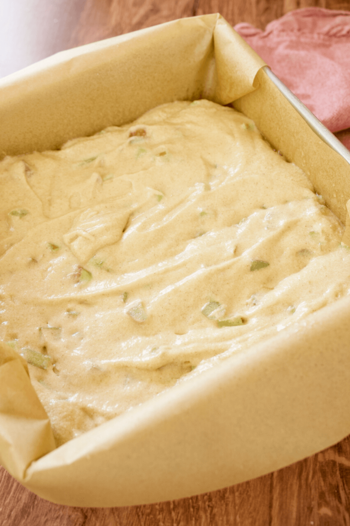 Rhubarb cake batter smoothed in 8x8 inch pan.