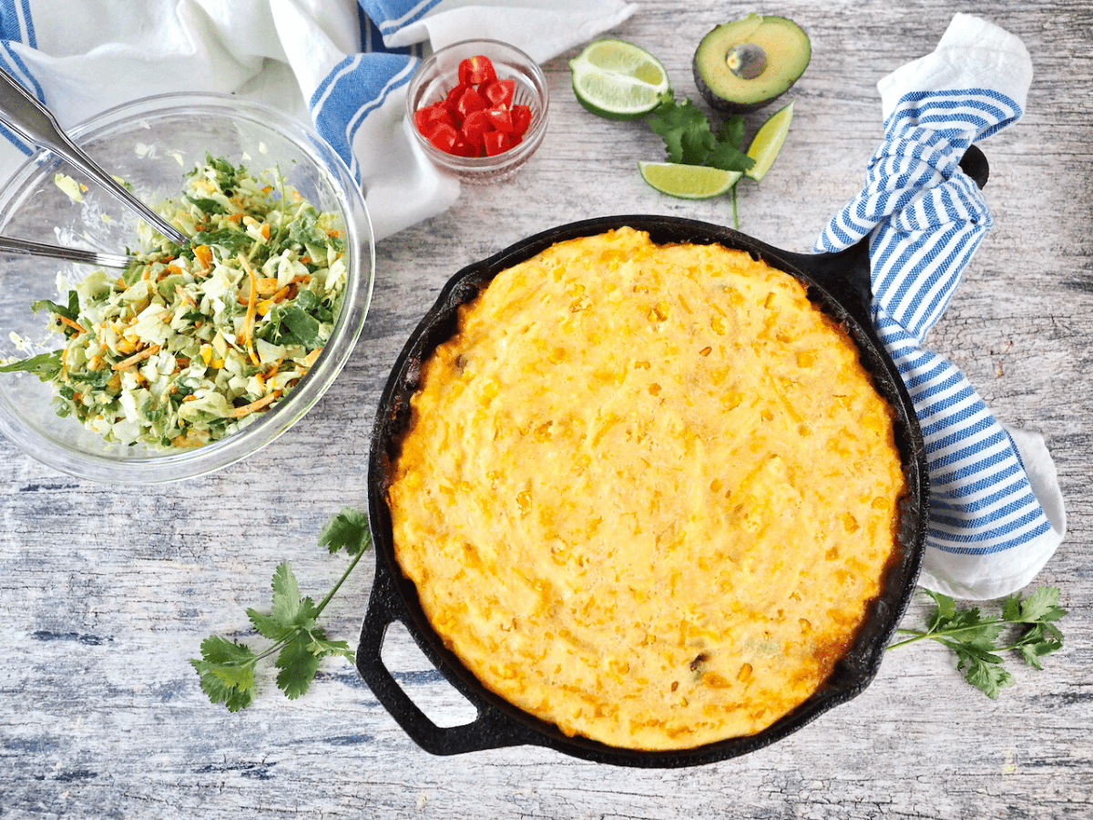 Tamale pie with salad and chopped tomatoes, avocado and cilantro.
