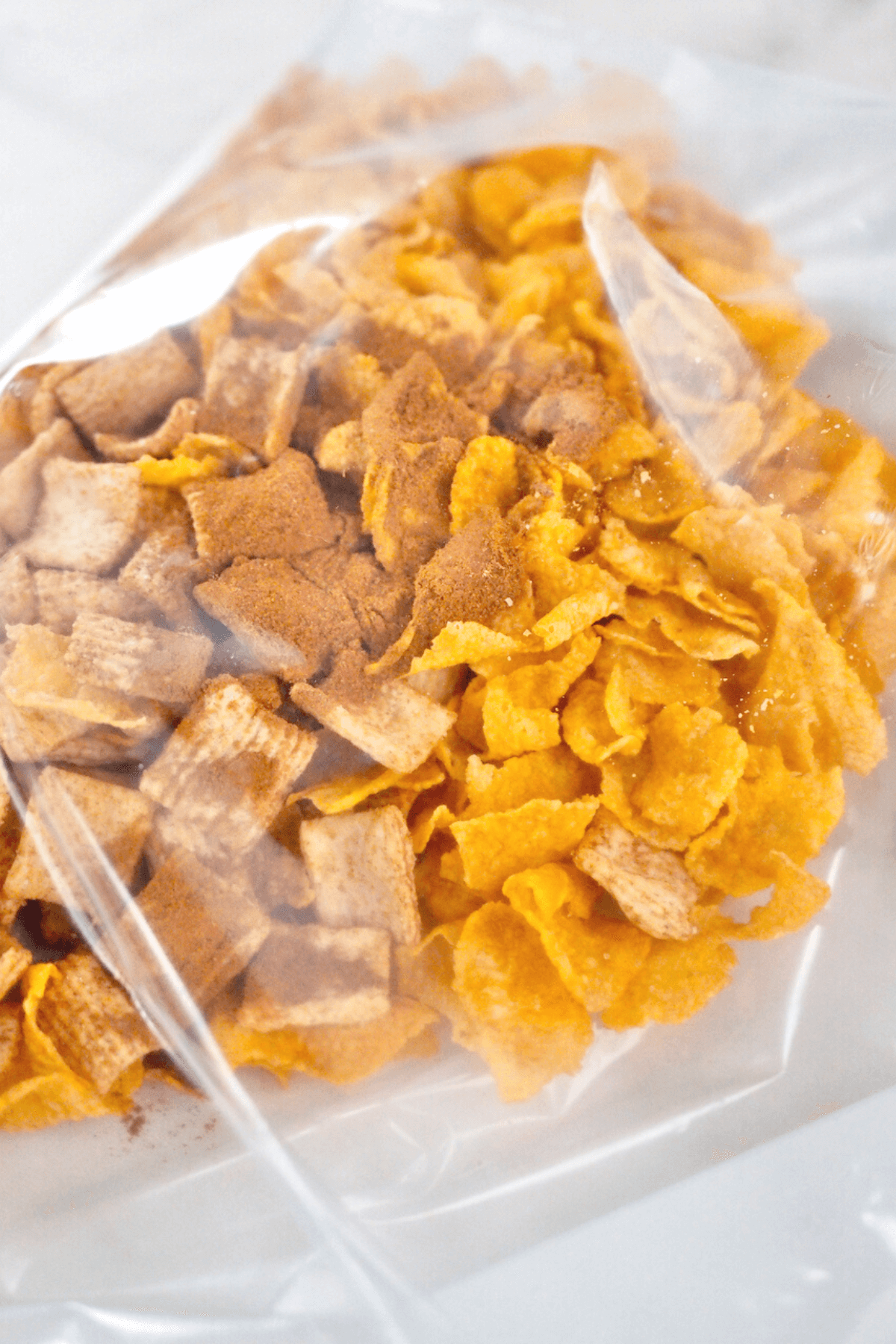 Cereal and cinnamon added to baggie for crushing. 