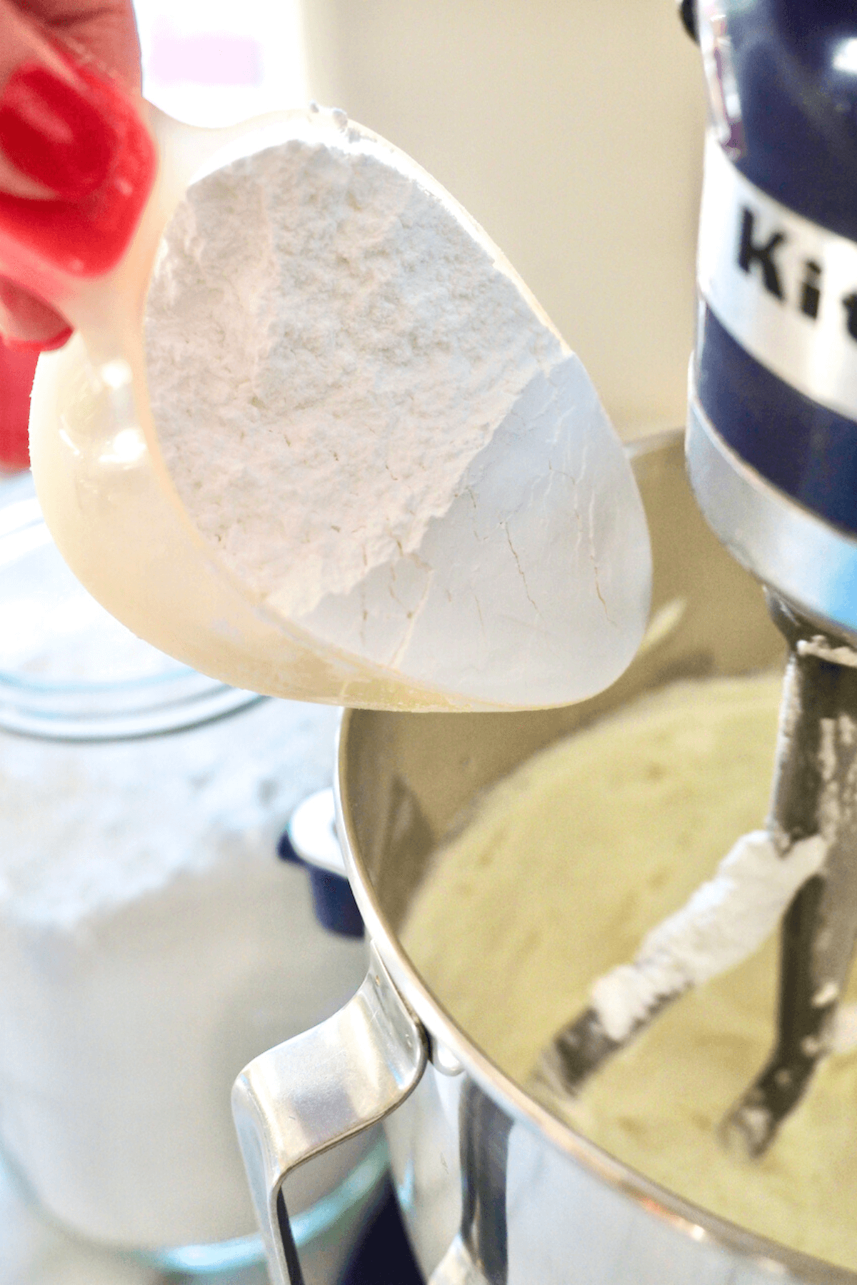 Adding Powdered sugar to Bailey's cream cheese frosting mixture. 
