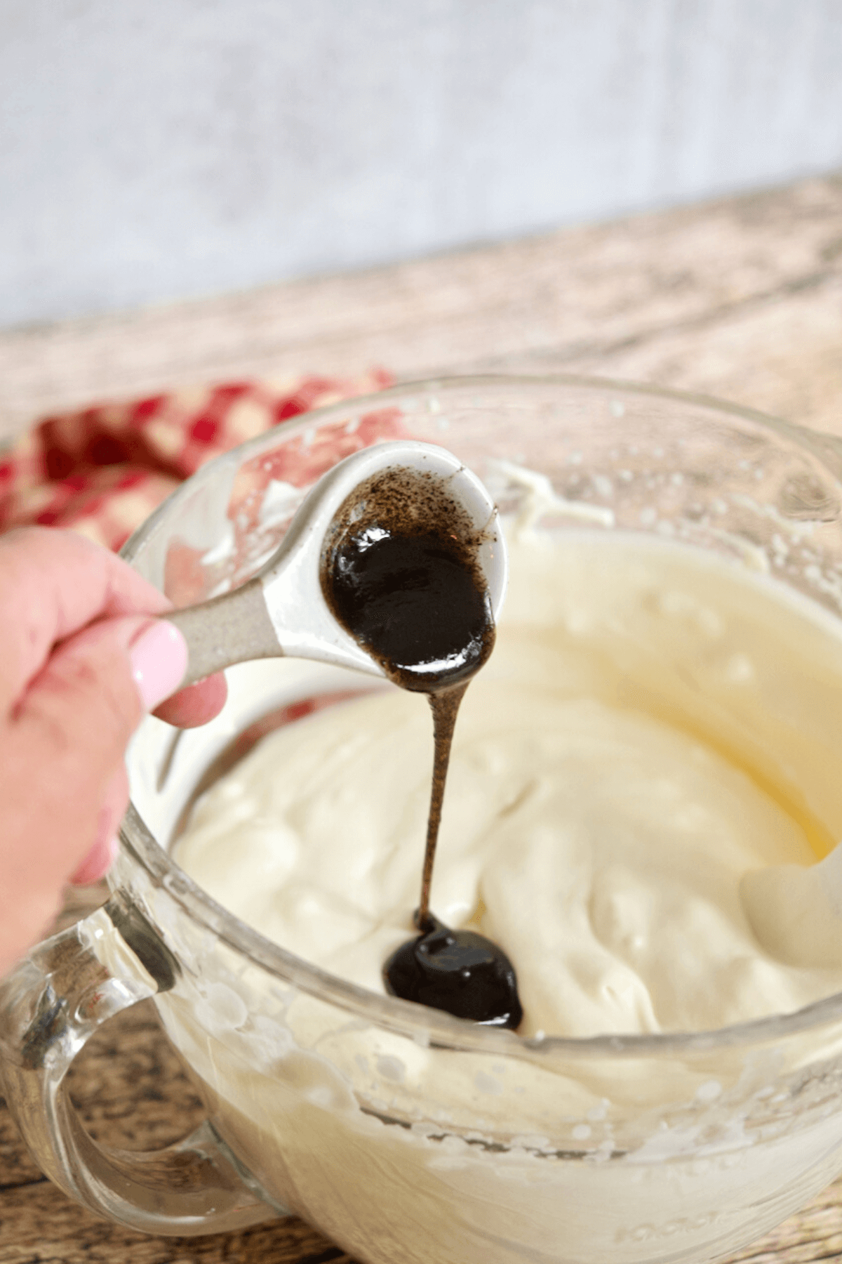 Adding vanilla bean paste into no churn moose tracks ice cream mixture. 