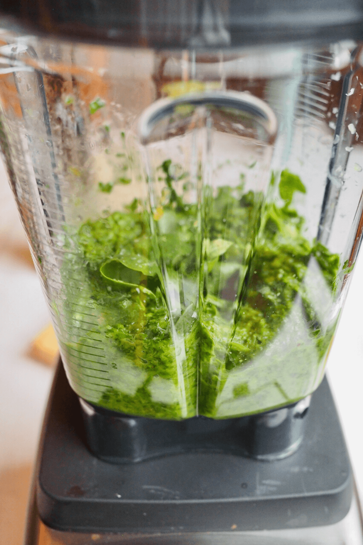 Blending or processing the spinach, basil and other pesto ingredients in blender. 